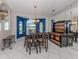 Bright dining room with white tile flooring, a dining table and a view to the landscaped lawn at 24339 Matias Ln, Punta Gorda, FL 33955