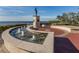 Scenic water fountain with a statue and brick pathway, overlooking the water and lush greenery at 24339 Matias Ln, Punta Gorda, FL 33955