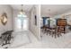 Elegant foyer with decorative tile flooring leading to a dining room with a large window at 24339 Matias Ln, Punta Gorda, FL 33955