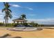 Picturesque gazebo with intricate compass design, surrounded by lush landscaping and waterfront views at 24339 Matias Ln, Punta Gorda, FL 33955