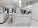 Open kitchen with tiled island, white cabinetry, and stainless steel appliances at 24339 Matias Ln, Punta Gorda, FL 33955