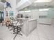 Island in kitchen with seating, white cabinetry, and stainless steel appliances at 24339 Matias Ln, Punta Gorda, FL 33955