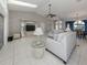 Spacious living room featuring high ceilings, tile floors, and comfortable seating arrangement at 24339 Matias Ln, Punta Gorda, FL 33955