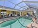 Outdoor patio including a large swimming pool, jacuzzi, and outdoor dining set at 24339 Matias Ln, Punta Gorda, FL 33955