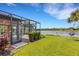 Beautiful backyard view showing the lanai, landscaping and serene lake at 2487 Marton Oak Blvd, North Port, FL 34289