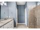 Stylish bathroom with double sinks, granite countertop, and a glass-enclosed shower at 2487 Marton Oak Blvd, North Port, FL 34289