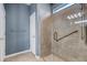 Modern bathroom features a glass shower with a built-in seat and handrails at 2487 Marton Oak Blvd, North Port, FL 34289