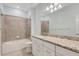 Bathroom features white vanity with granite countertop, tiled shower, and matching tile floors at 2487 Marton Oak Blvd, North Port, FL 34289