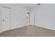 Bright bedroom with carpeting, closet, and ensuite bathroom entrance at 2487 Marton Oak Blvd, North Port, FL 34289