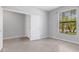 Bedroom with light gray walls, tiled floors, closet, and a window for natural light at 2487 Marton Oak Blvd, North Port, FL 34289