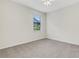 Carpeted bedroom with a ceiling fan and a window offering natural light at 2487 Marton Oak Blvd, North Port, FL 34289