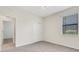 Cozy carpeted bedroom featuring a window and a closet with double doors at 2487 Marton Oak Blvd, North Port, FL 34289