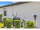 Exterior view showcasing the home's mechanical equipment with lush landscaping at 2487 Marton Oak Blvd, North Port, FL 34289