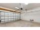 Garage space with an automatic door, overhead lighting and wooden storage shelves at 2487 Marton Oak Blvd, North Port, FL 34289