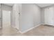Tile hallway with neutral colored walls and white trim, leading to other rooms at 2487 Marton Oak Blvd, North Port, FL 34289