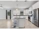 Contemporary kitchen featuring white cabinets, stainless appliances, and island with seating at 2487 Marton Oak Blvd, North Port, FL 34289