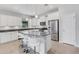 Modern kitchen with white cabinetry, stainless steel appliances, and a large center island at 2487 Marton Oak Blvd, North Port, FL 34289