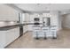 Bright, open kitchen with stainless appliances, white cabinets, and breakfast bar at 2487 Marton Oak Blvd, North Port, FL 34289