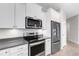 Modern kitchen features stainless steel appliances and white cabinetry at 2487 Marton Oak Blvd, North Port, FL 34289