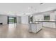 Bright, open kitchen with stainless steel appliances and an island with bar seating at 2487 Marton Oak Blvd, North Port, FL 34289