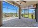 Relaxing lanai featuring brick pavers and views of the serene lake at 2487 Marton Oak Blvd, North Port, FL 34289