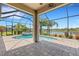 Enclosed lanai featuring a pool, hot tub, and views of the beautiful lake at 2487 Marton Oak Blvd, North Port, FL 34289