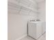 Functional laundry room equipped with a washer, dryer, and wire shelving for storage at 2487 Marton Oak Blvd, North Port, FL 34289