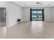 Open-concept living space with tile flooring and sliding doors to outdoor living area at 2487 Marton Oak Blvd, North Port, FL 34289