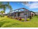 A screened-in pool and spa area with colorful landscaping offering a private outdoor oasis at 2487 Marton Oak Blvd, North Port, FL 34289