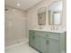 Updated bathroom featuring a double vanity, stylish mirrors, and walk-in shower at 26115 Rampart Blvd, Punta Gorda, FL 33983