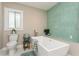Relaxing bathroom with a soaking tub, decorative tile, and natural light at 26115 Rampart Blvd, Punta Gorda, FL 33983