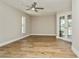 Spacious bedroom with wood-look tile flooring and a ceiling fan at 26115 Rampart Blvd, Punta Gorda, FL 33983