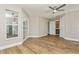 Large bedroom with wood-look tile flooring and access to bathroom and kitchen at 26115 Rampart Blvd, Punta Gorda, FL 33983