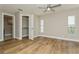 Spacious bedroom with natural light, wood-look tile flooring, and a walk-in closet at 26115 Rampart Blvd, Punta Gorda, FL 33983