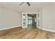 Bright bedroom with wood-look tile flooring and french doors leading to the pool at 26115 Rampart Blvd, Punta Gorda, FL 33983