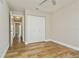 Cozy bedroom with wood-look tile flooring, ceiling fan, and a closet at 26115 Rampart Blvd, Punta Gorda, FL 33983