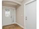 Bright foyer with a decorative glass front door, sidelight, wood-look tile flooring, and neutral walls at 26115 Rampart Blvd, Punta Gorda, FL 33983