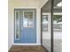 Welcoming front door with decorative glass, sidelight, and covered entryway with tile flooring at 26115 Rampart Blvd, Punta Gorda, FL 33983