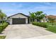 Charming single-story home featuring a well-maintained lawn, a two-car garage, and neatly trimmed landscaping at 26115 Rampart Blvd, Punta Gorda, FL 33983