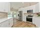 Modern kitchen with stainless steel appliances, backsplash, and ample counter space at 26115 Rampart Blvd, Punta Gorda, FL 33983