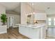 Open kitchen with a large island, pendant lighting, and modern finishes at 26115 Rampart Blvd, Punta Gorda, FL 33983