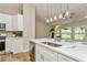 Bright kitchen island with stainless sink and seating for casual dining at 26115 Rampart Blvd, Punta Gorda, FL 33983