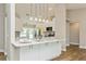 Bright kitchen features white cabinetry, quartz countertops, and stainless steel appliances at 26115 Rampart Blvd, Punta Gorda, FL 33983