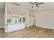 Bright, open kitchen featuring white cabinets, a central island with seating, and wood-look tile flooring at 26115 Rampart Blvd, Punta Gorda, FL 33983