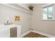 Functional laundry room with utility sink, shelf, and window at 26115 Rampart Blvd, Punta Gorda, FL 33983