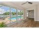 Living room area with view of screened pool area through sliding glass doors at 26115 Rampart Blvd, Punta Gorda, FL 33983