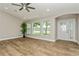 Open living room featuring wood-look tile flooring, recessed lighting, and large windows with natural light at 26115 Rampart Blvd, Punta Gorda, FL 33983