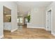 Open-concept living area boasts wood-look tile flooring, natural light and neutral paint palette at 26115 Rampart Blvd, Punta Gorda, FL 33983