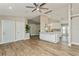 Open-concept living area with vaulted ceilings, recessed lights, wood-look tile, and a kitchen island at 26115 Rampart Blvd, Punta Gorda, FL 33983