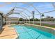 Beautifully designed pool with a jacuzzi, screened enclosure, and serene backyard at 26115 Rampart Blvd, Punta Gorda, FL 33983